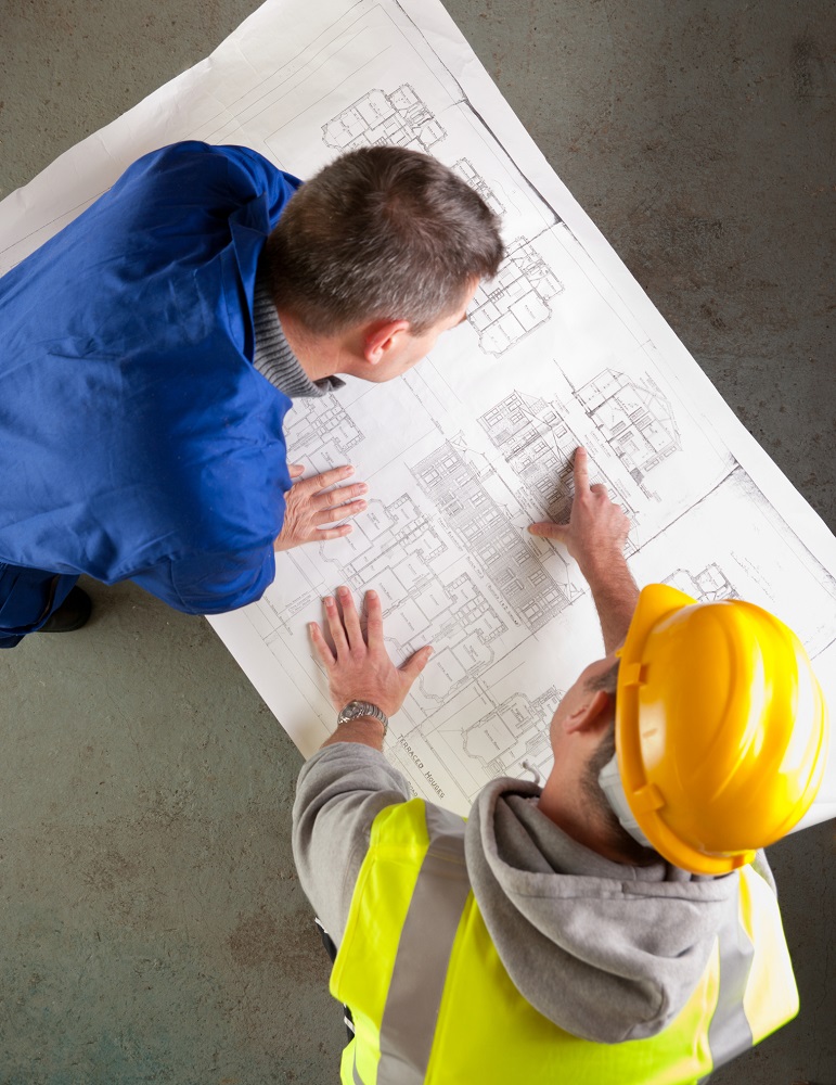builders-examine-blueprints-16608088